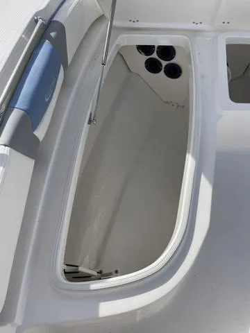Slide: The Image of 2024 Robalo 206 Cayman boat storage compartment with cup holders. - 28