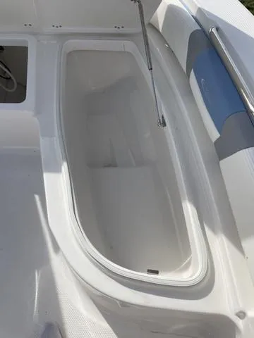 Slide: The Image of 2024 Robalo 206 Cayman boat storage compartment and seating area. - 30