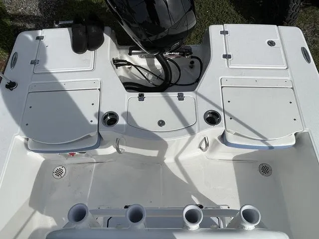 Slide: The Image of 2024 Robalo 206 Cayman boat deck with storage compartments and rod holders. - 35