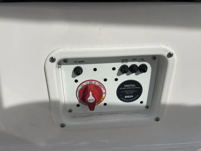 Slide: The Image of Control panel of 2024 Robalo 206 Cayman boat with digital voltage relay. - 36