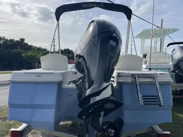 Slide: The Image of 2024 Robalo 206 Cayman boat with outboard motor and swim ladder. - 6