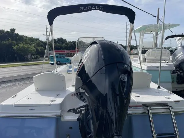 Slide: The Image of 2024 Robalo 206 Cayman boat with outboard motor and bimini top. - 8