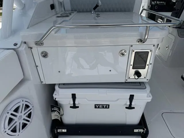 Slide: The Image of 2024 Blackfin 302DC boat with Yeti cooler and Kenyon grill. - 12