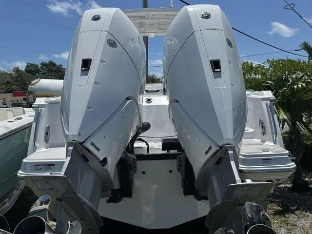 Slide: The Image of 2024 Blackfin 302DC boat with dual outboard engines. - 2