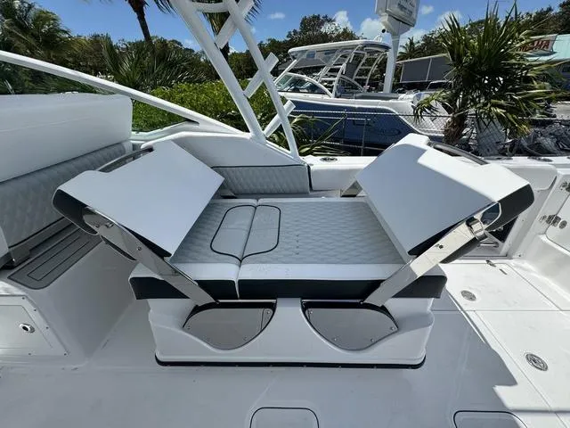 Slide: The Image of 2024 Blackfin 302DC boat with adjustable seating in a marina. - 20