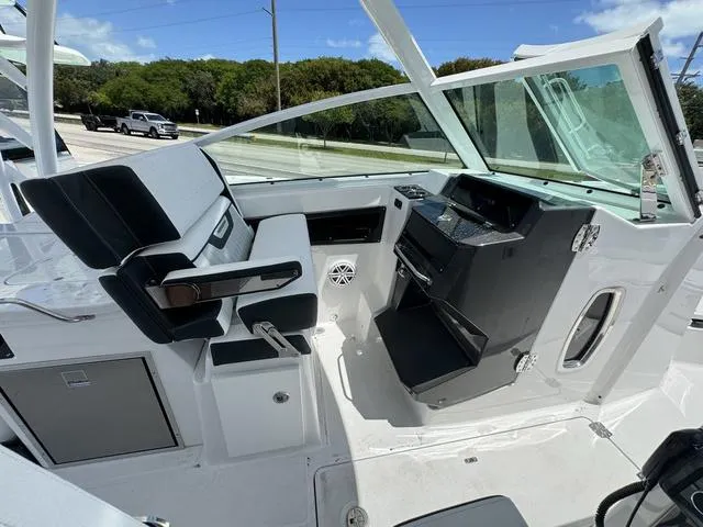 Slide: The Image of 2024 Blackfin 302DC boat cockpit with modern helm and seating. - 22