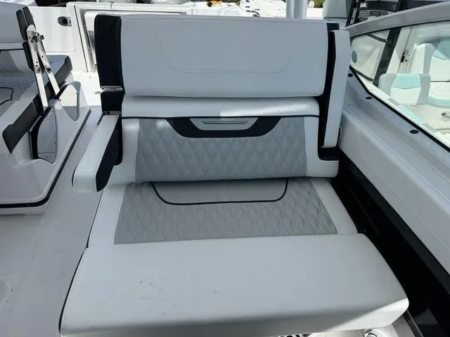 Slide: The Image of 2024 Blackfin 302DC boat interior seating with diamond-stitched upholstery. - 23