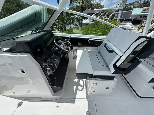 Slide: The Image of 2024 Blackfin 302DC boat cockpit with modern steering console and seating. - 26