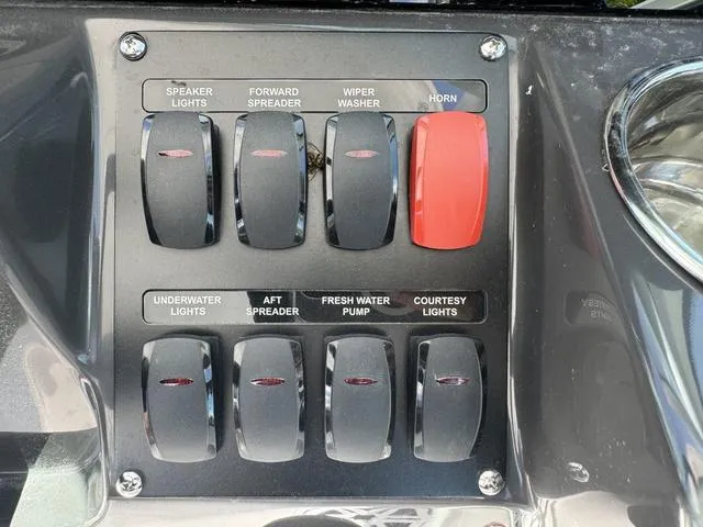 Slide: The Image of Control panel of a 2024 Blackfin 302DC boat with various switches. - 30