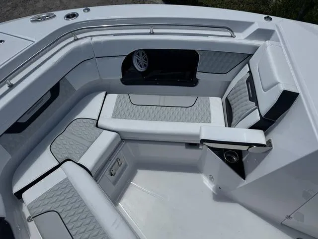 Slide: The Image of 2024 Blackfin 302DC boat interior with cushioned seating and speaker. - 34