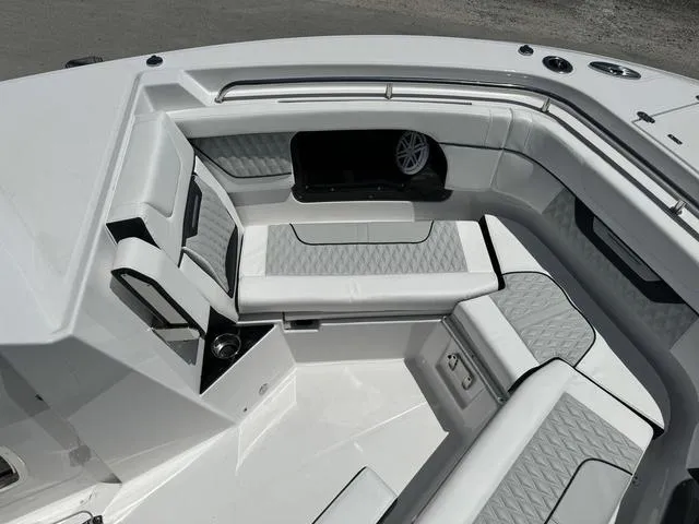 Slide: The Image of 2024 Blackfin 302DC boat interior with cushioned seating and storage compartments. - 35