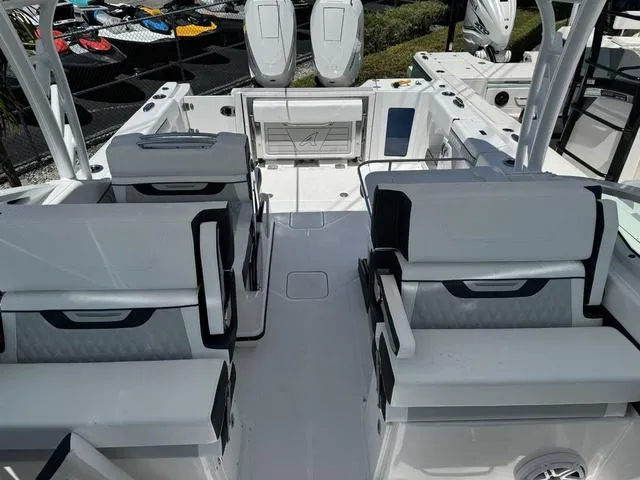Slide: The Image of 2024 Blackfin 302DC boat interior with seating and dual outboard motors. - 40