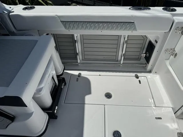 Slide: The Image of 2024 Blackfin 302DC boat deck with storage compartments and seating. - 5