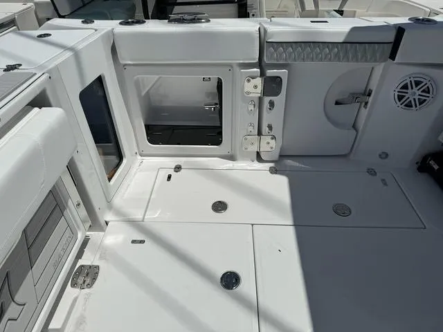 Slide: The Image of 2024 Blackfin 302DC boat deck with storage compartments and seating. - 7