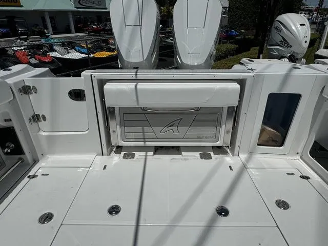 Slide: The Image of 2024 Blackfin 302DC boat deck with storage compartment and twin outboard motors. - 8