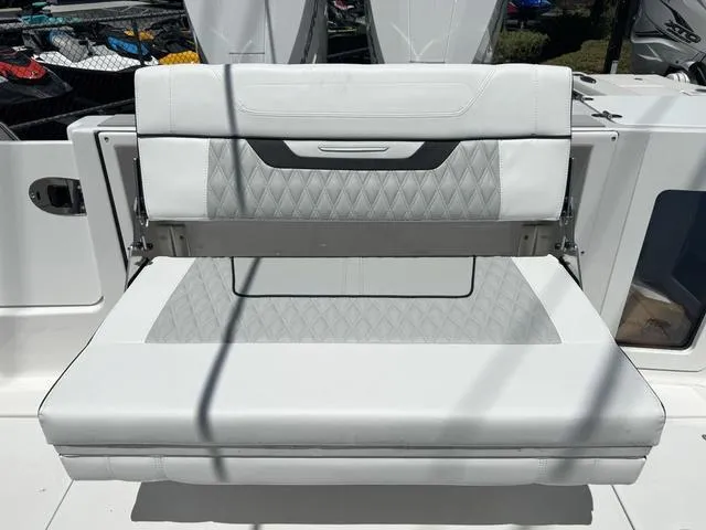 Slide: The Image of 2024 Blackfin 302DC boat with white cushioned seating. - 9