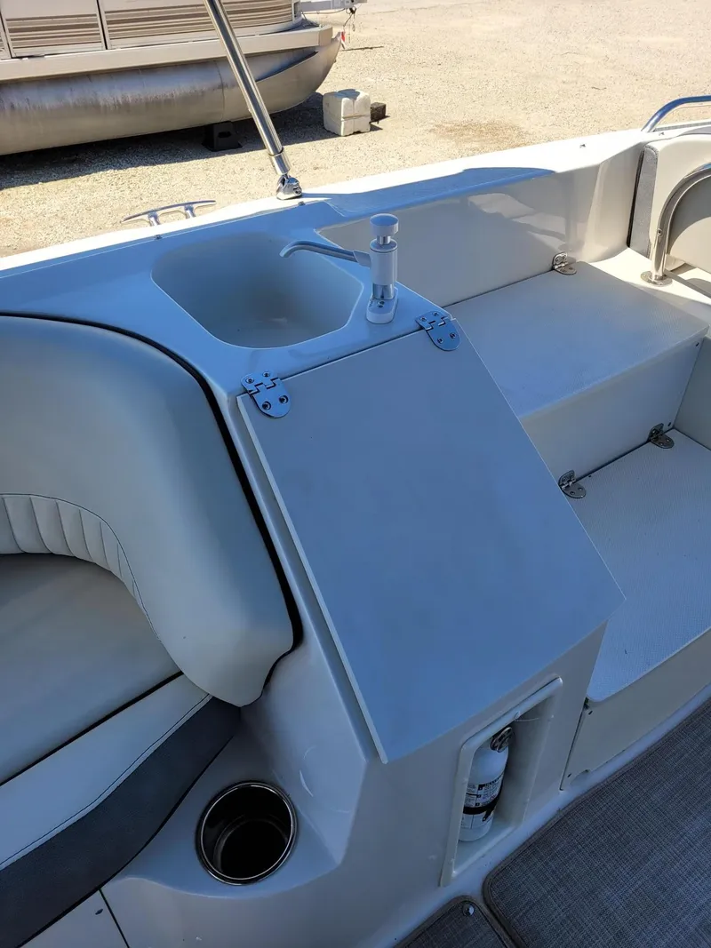 Slide: The Image of 2022 Stingray 212SC boat interior with sink and seating area. - 10