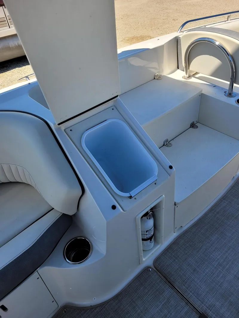 Slide: The Image of 2022 Stingray 212SC boat interior with seating, storage, and fire extinguisher. - 11