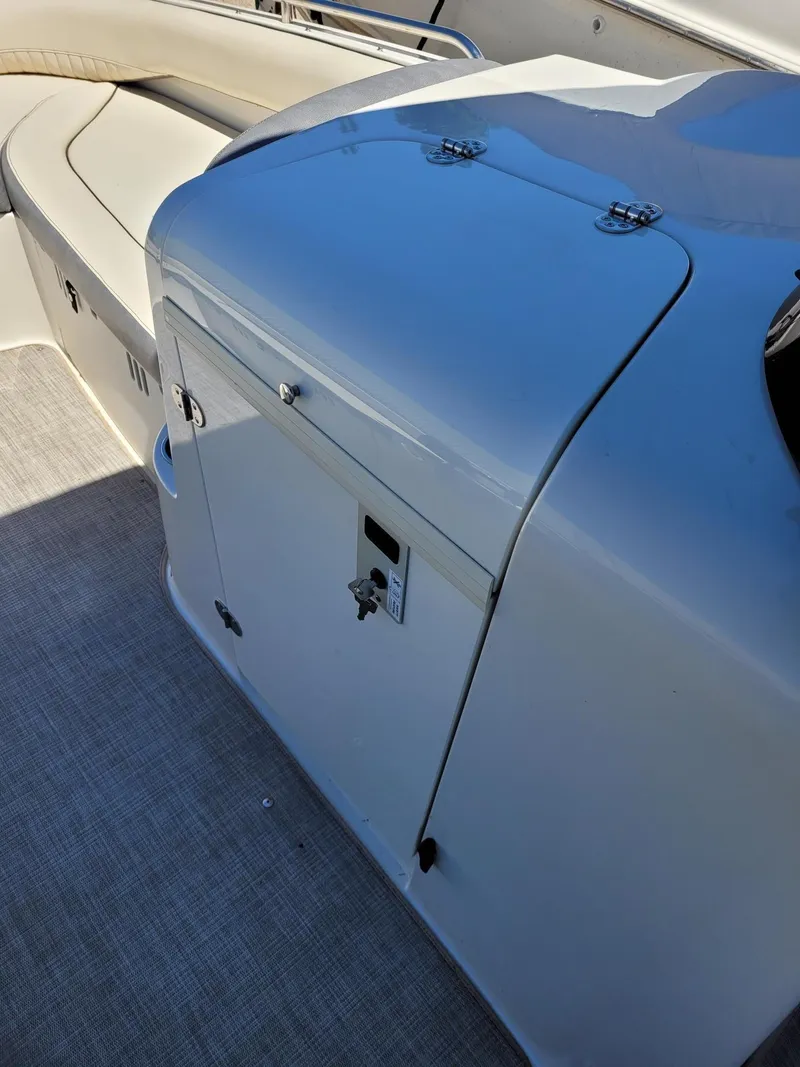 Slide: The Image of 2022 Stingray 212SC boat interior with cushioned seating and storage compartment. - 17