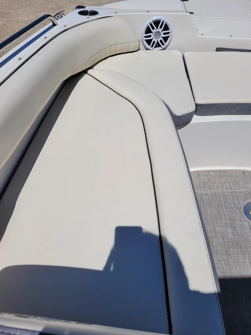 Slide: The Image of 2022 Stingray 212SC boat interior with white cushioned seating and speaker. - 21