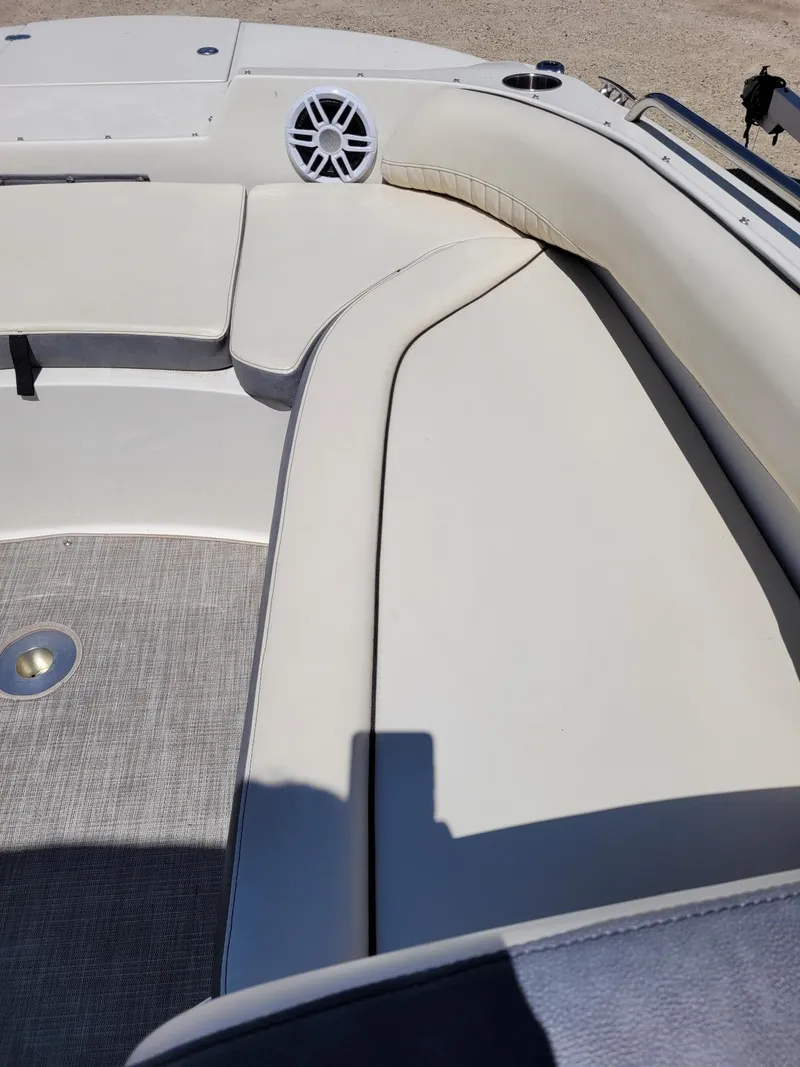 Slide: The Image of 2022 Stingray 212SC boat interior with cushioned seating and speaker. - 22