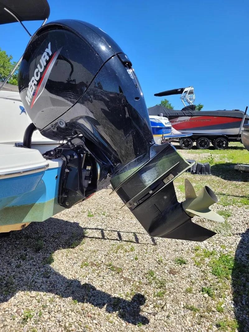 Slide: The Image of 2022 Stingray 212SC boat with Mercury outboard motor in a marina. - 3