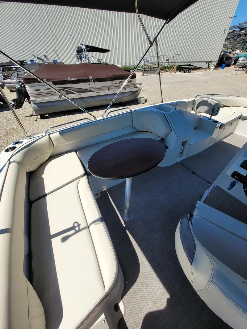 Slide: The Image of 2022 Stingray 212SC boat interior with seating and table. - 6