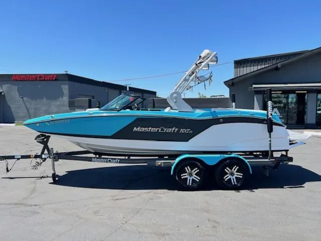 Slide: The Image of 2019 MasterCraft NXT20 boat on a trailer in a parking lot. - 1
