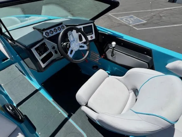 Slide: The Image of 2019 MasterCraft NXT20 boat interior with steering wheel and captain's chair. - 11