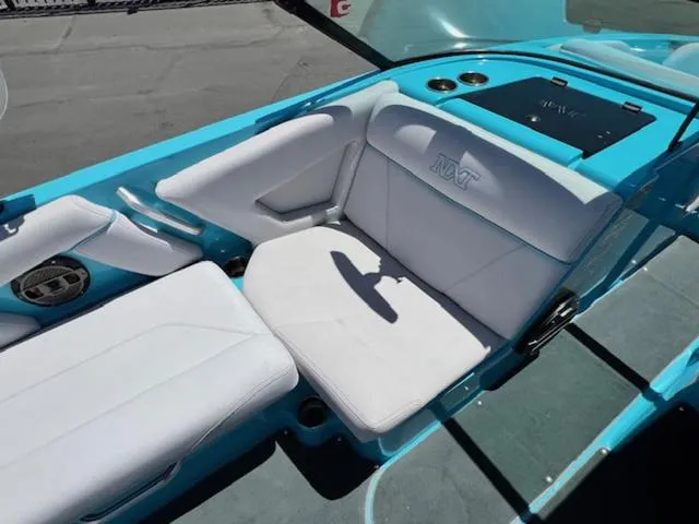 Slide: The Image of 2019 MasterCraft NXT20 boat interior with white seating and turquoise accents. - 12