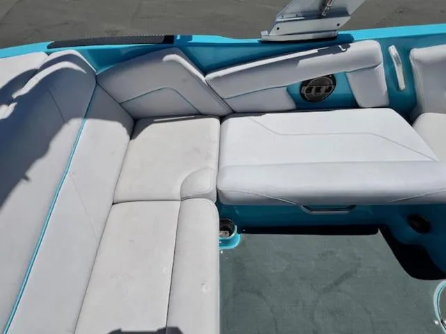 Slide: The Image of 2019 MasterCraft NXT20 boat interior with white and blue seating. - 13