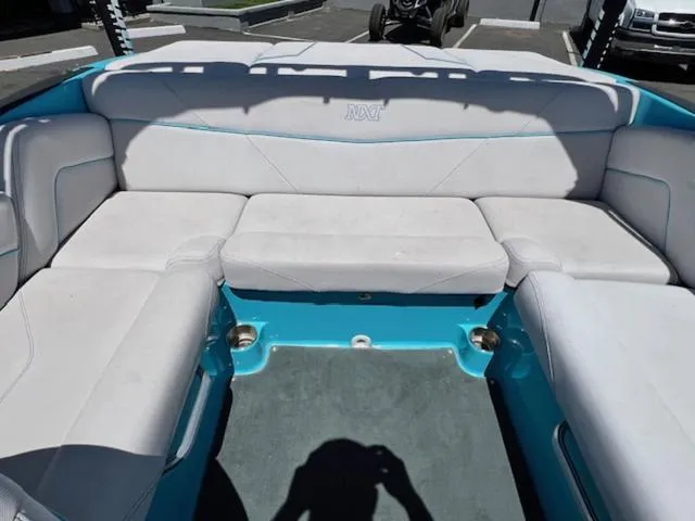 Slide: The Image of 2019 MasterCraft NXT20 boat interior with white and blue seating. - 14