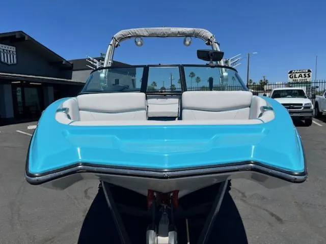 Slide: The Image of 2019 MasterCraft NXT20 boat with blue hull and white interior. - 3