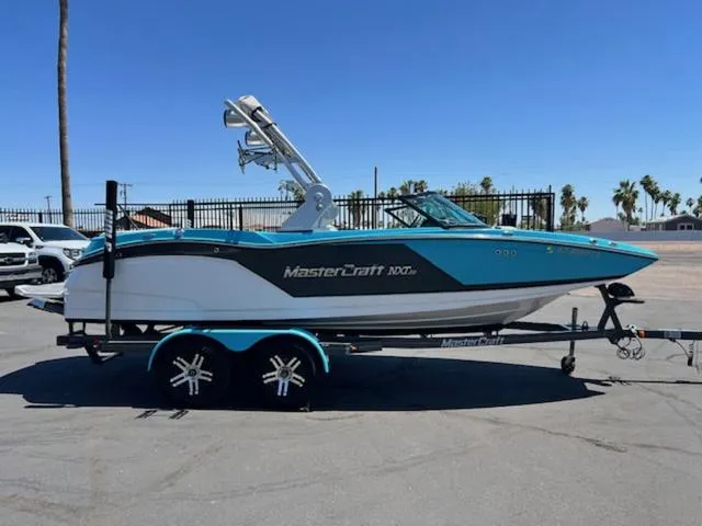 Slide: The Image of 2019 MasterCraft NXT20 boat on trailer in parking lot. - 5