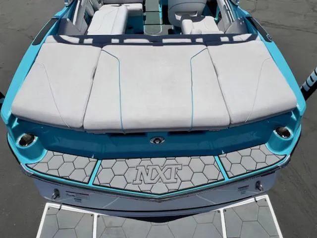 Slide: The Image of 2019 MasterCraft NXT20 boat with blue and white interior, rear view. - 9