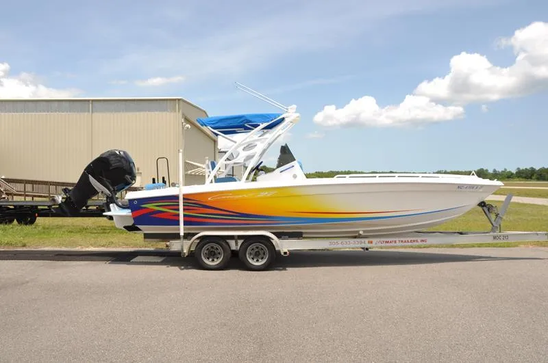 Slide: The Image of 2009 Concept 27' CC boat with colorful graphics on a trailer. - 1