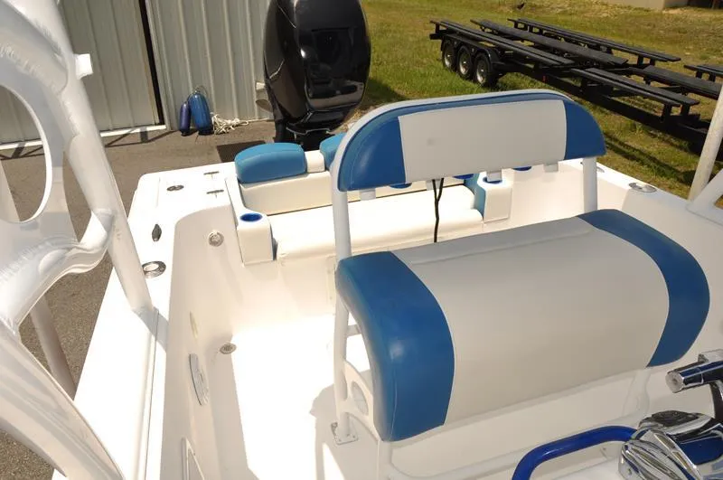 Slide: The Image of 2009 Concept 27' CC boat with blue and white seating, outboard motor, and trailer in background. - 17