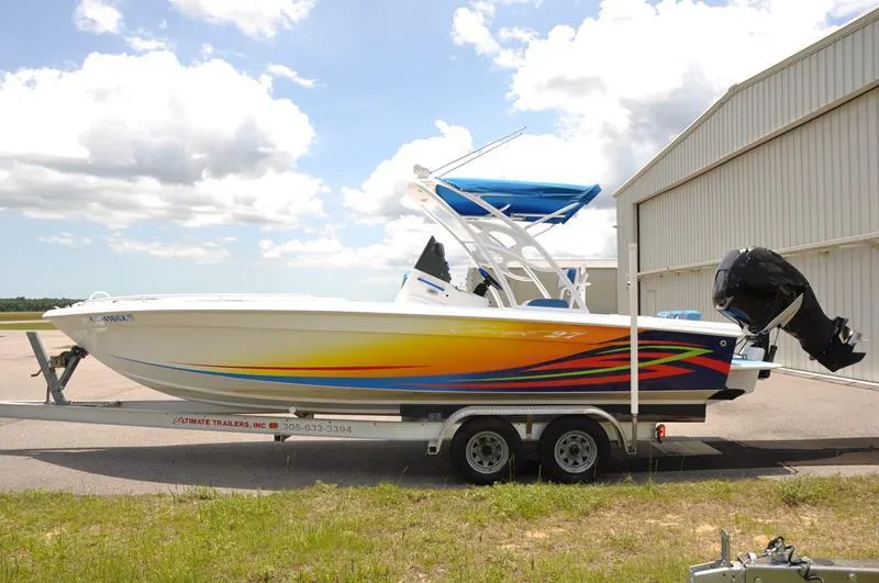 Slide: The Image of 2009 Concept 27' CC boat with colorful graphics on a trailer. - 5