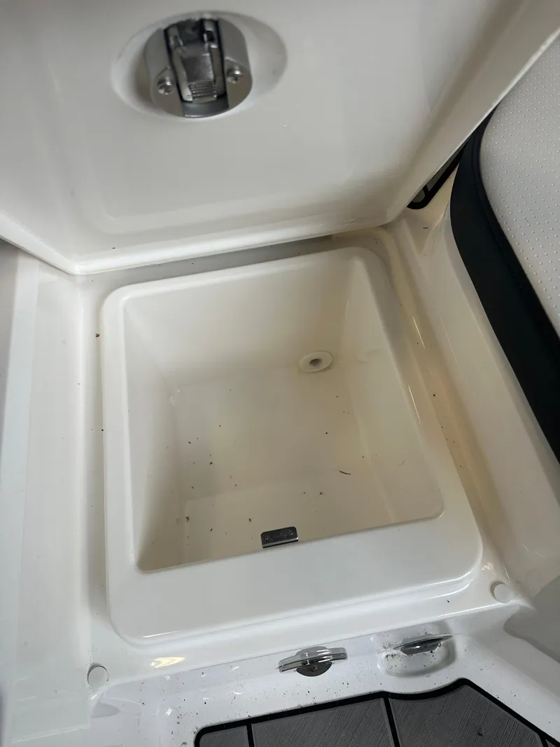 Slide: The Image of 2024 Sea Ray SPX 210 storage compartment, open and empty. - 11