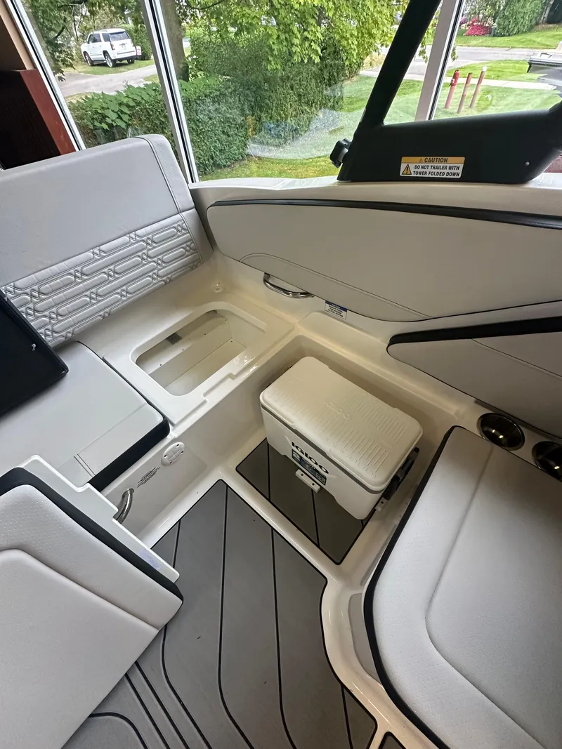 Slide: The Image of 2024 Sea Ray SPX 210 boat interior with seating and storage. - 12