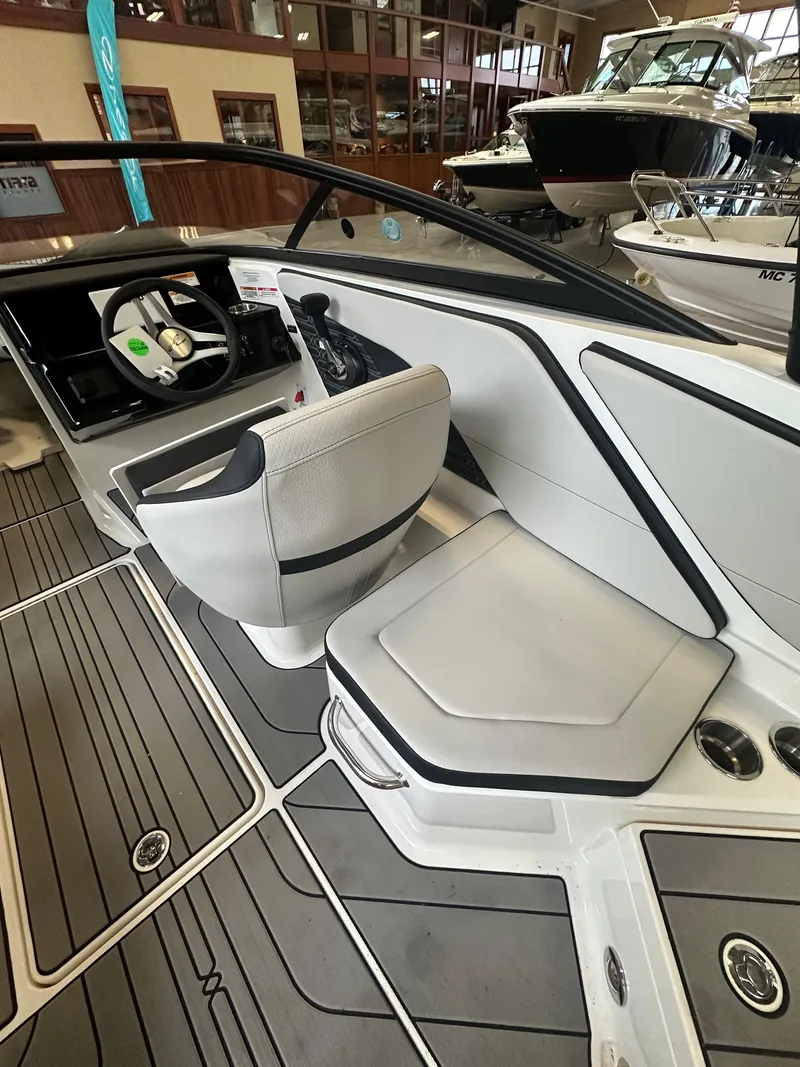 Slide: The Image of 2024 Sea Ray SPX 210 boat interior with modern seating and sleek design. - 14