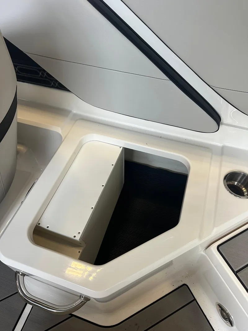 Slide: The Image of 2024 Sea Ray SPX 210 boat storage compartment with sleek design. - 16