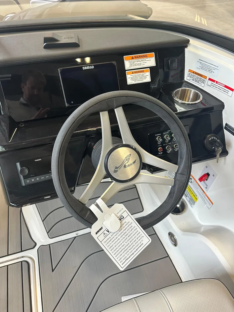 Slide: The Image of 2024 Sea Ray SPX 210 boat dashboard with steering wheel and controls. - 17