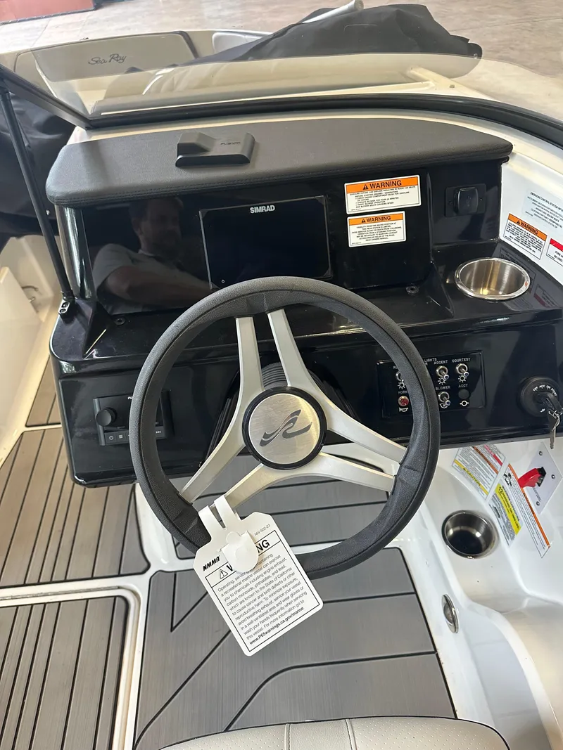 Slide: The Image of 2024 Sea Ray SPX 210 boat dashboard with steering wheel and controls. - 18