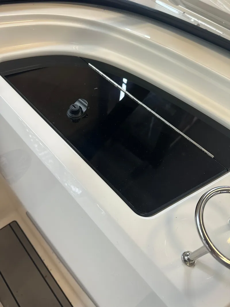 Slide: The Image of 2024 Sea Ray SPX 210 boat interior detail with sleek black panel. - 20
