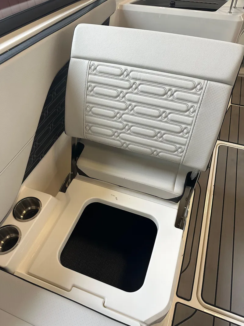 Slide: The Image of 2024 Sea Ray SPX 210 boat seat with storage compartment and cup holders. - 23