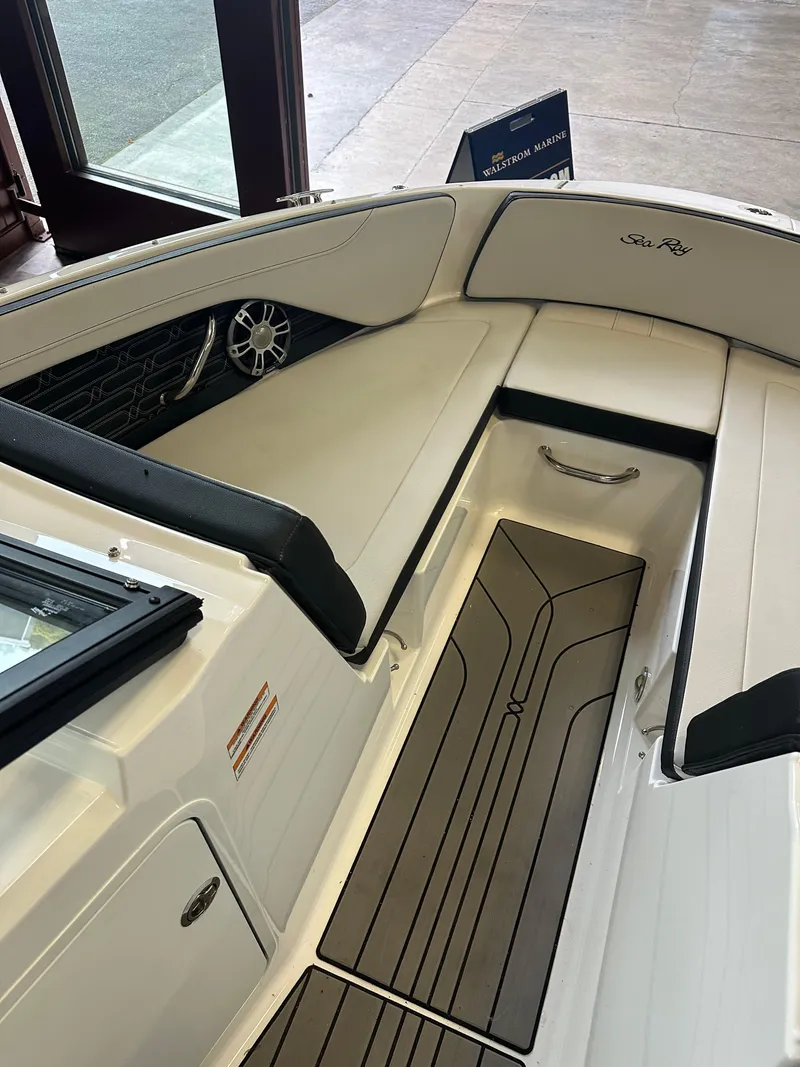 Slide: The Image of 2024 Sea Ray SPX 210 boat interior with sleek seating and modern design. - 27