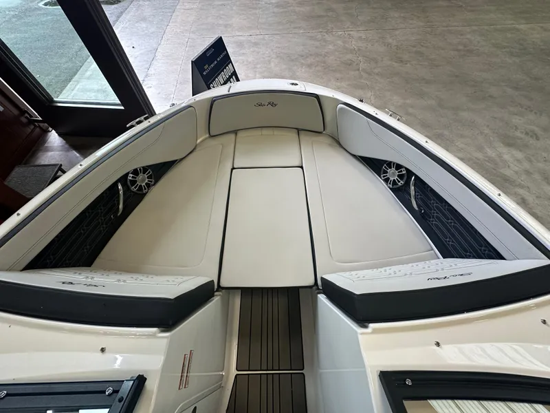Slide: The Image of 2024 Sea Ray SPX 210 boat interior with white seating and sleek design. - 30