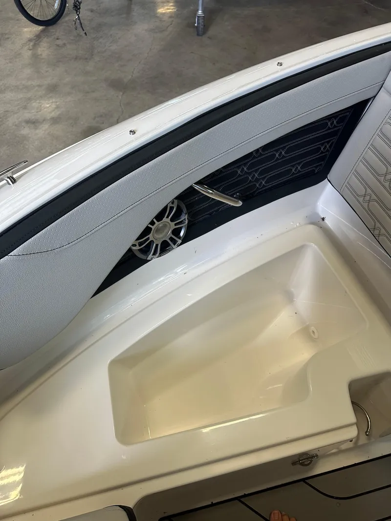 Slide: The Image of 2024 Sea Ray SPX 210 boat interior detail with speaker and storage compartment. - 32