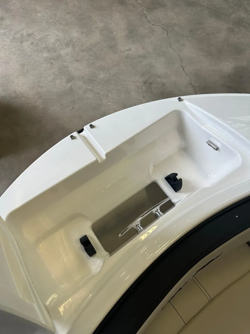 Slide: The Image of 2024 Sea Ray SPX 210 boat storage compartment, white interior, close-up view. - 34